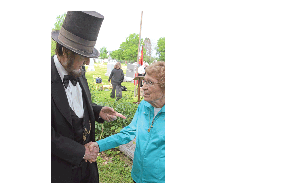 Abraham Lincoln, portrayed by Max Daniels of Wheaton, greets Maureen Granger of Aurora