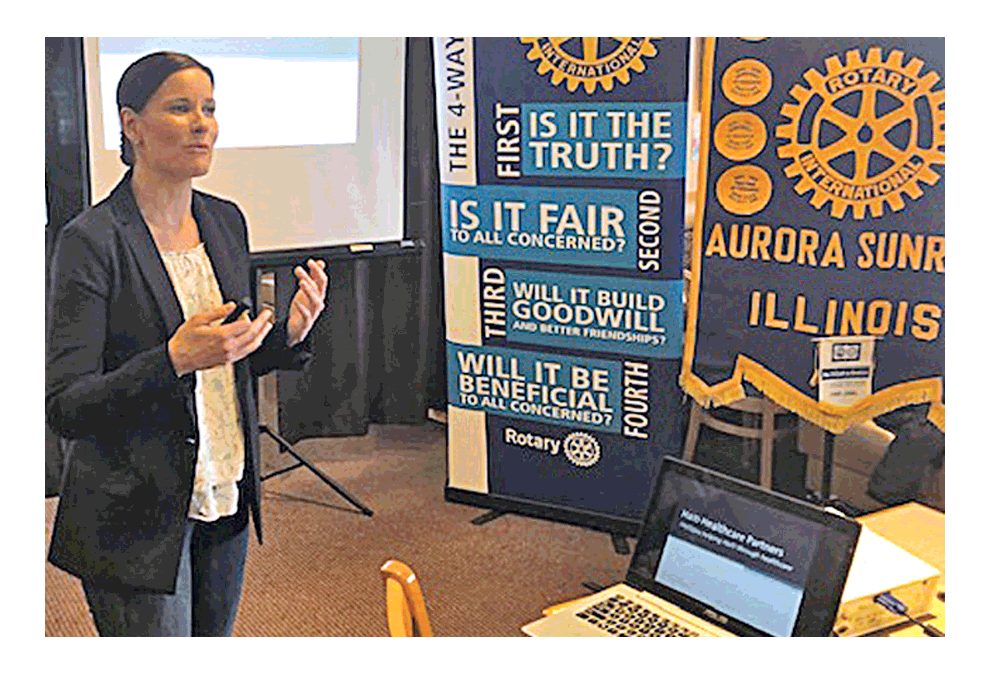 Sara Simeunovic tells the members of the Aurora Sunrise Rotary Club last week about the difficulties that 70% of Haitians have in getting health care