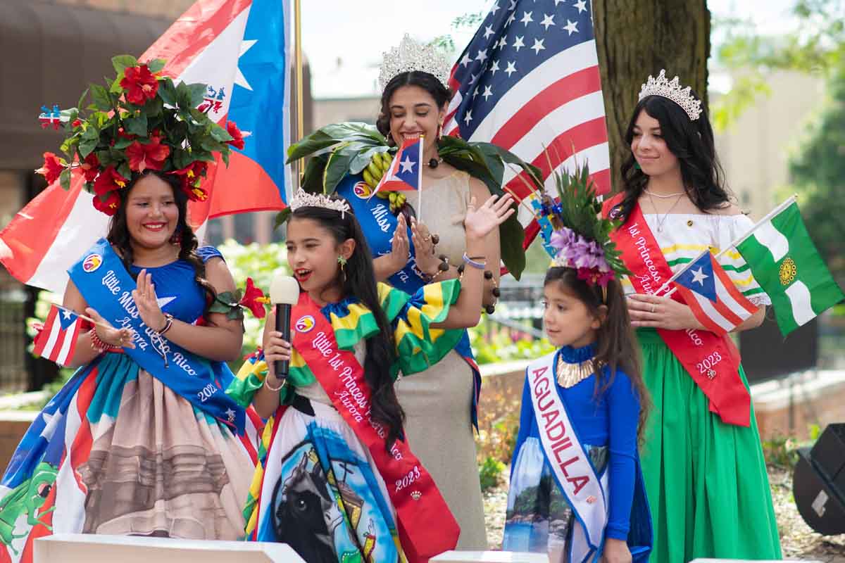 The First Princess of the Little Miss Puerto Rican Pageant, Eliana Valdovinos, energizes the crowd with a speech about her family’s hometown in Puerto Rico, Friday, July 21. All members of the pageant court spoke at the Puerto Rican Flag Raising Ceremony in Aurora.