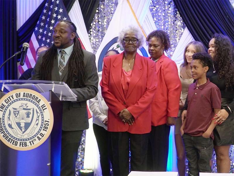 New Aurora Ward 7 alderman Brandon Tolliver, 34, is flanked by family members as he speaks to a crowd of more than 250 people in attendance tonight as his swearing in ceremony. City of Aurora government photo