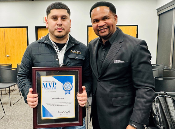 City of Aurora Community Outreach Specialist Brian Moreno receives the Mayor’s MVP Award from Aurora Mayor Richard Irvin for his heroic actions this past weekend in protecting warming center guests from gunman.
