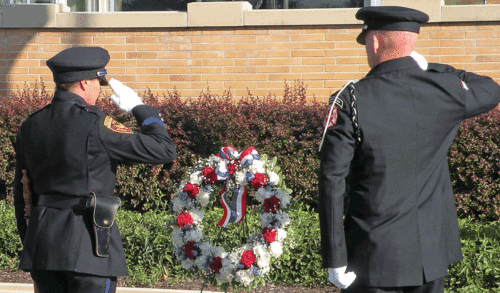 A salute after laying a wreath at the Aurora Police Department Tuesday is a commemoration of the 9-11 attack on buildings in the United States September 11, 2001. A moment of silence was observed at 8:46 a.m. to coincide with the first plane that was flown into the north World Trade Center tower. The tragedy struck on a Tuesday 17 years ago. See facebook.com/thevoice.us. Jason Crane/The Voice